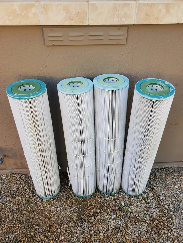 Four new white filter cartridges standing on the deck